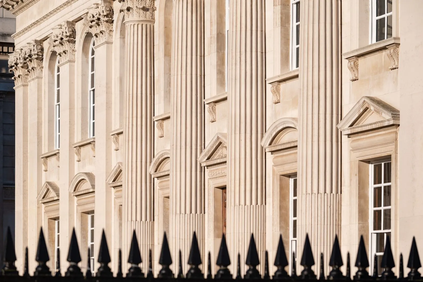 Detailed view of a neoclassical building facade with columns in Cambridge, UK.